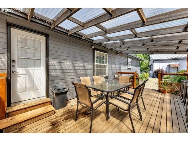 a view of a patio with table and chairs with wooden floor