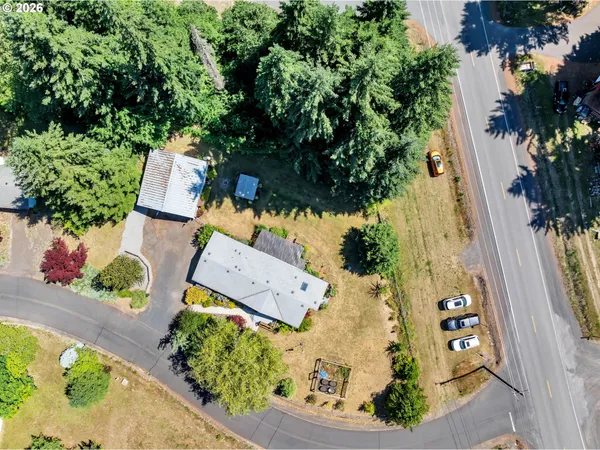 an aerial view of a house with a yard and garden