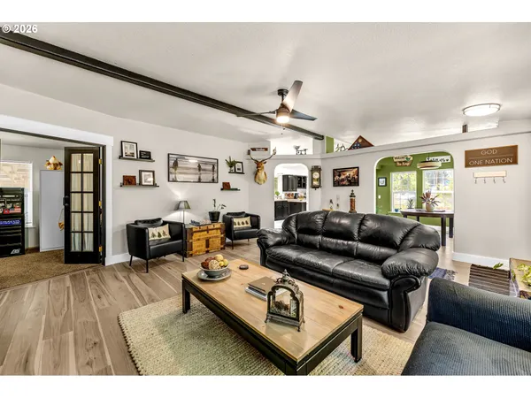 a living room with furniture and wooden floor