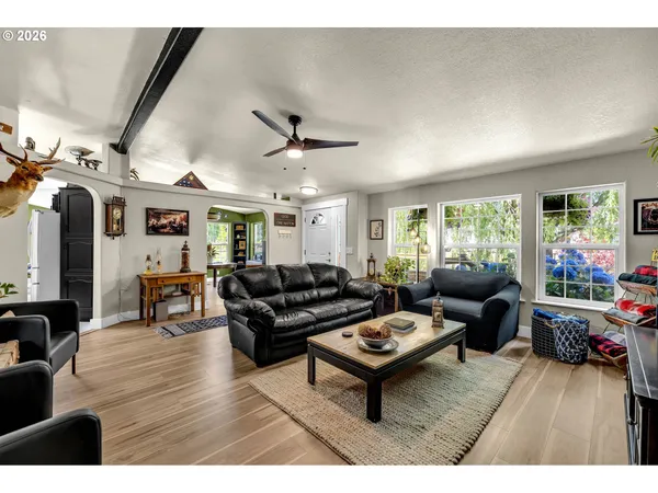 a living room with furniture and wooden floor