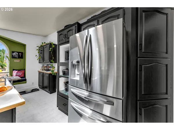 a metallic refrigerator freezer sitting in a kitchen