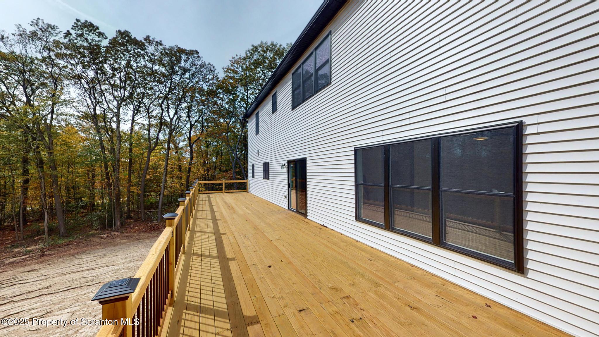 99 Woodland Drive Lake Ariel, PA 18436 - Photo 20 of 124 a view of balcony with a large window and wooden floor