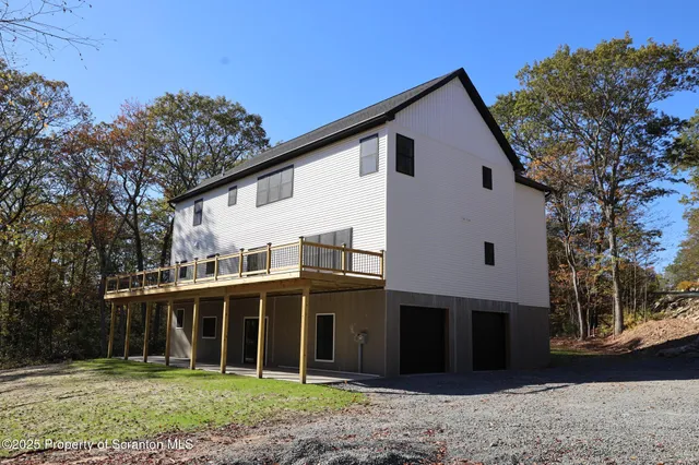 a view of a livingroom with a ceiling fan and window