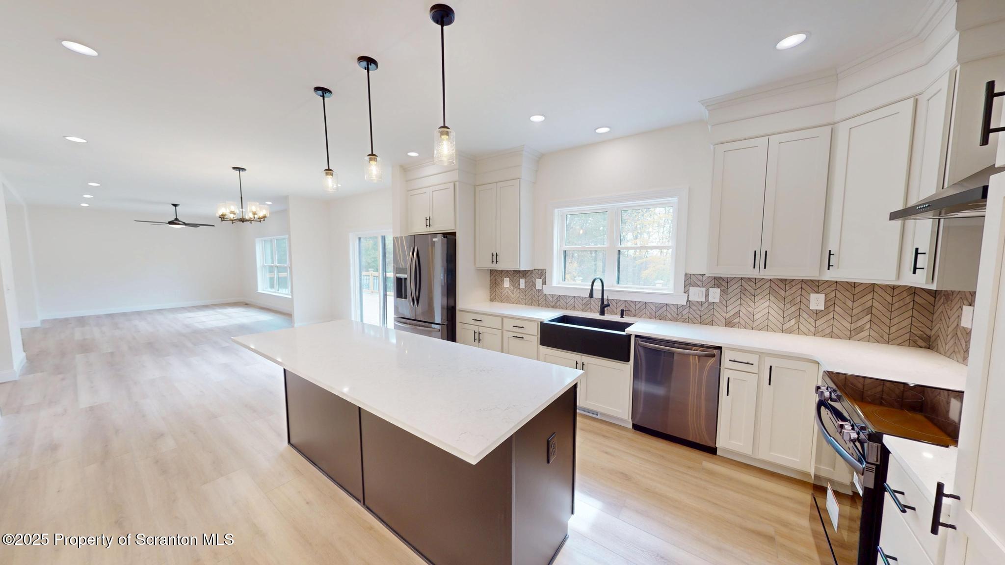 99 Woodland Drive Lake Ariel, PA 18436 - Photo 30 of 124 a large kitchen with stainless steel appliances kitchen island a large island in the center