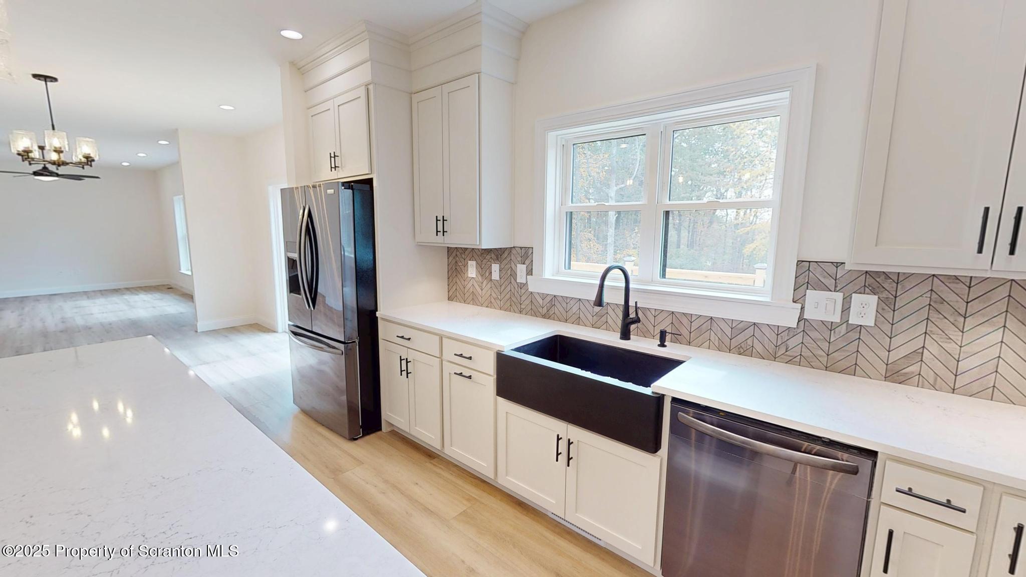 99 Woodland Drive Lake Ariel, PA 18436 - Photo 32 of 124 a kitchen with stainless steel appliances granite countertop a sink and a refrigerator