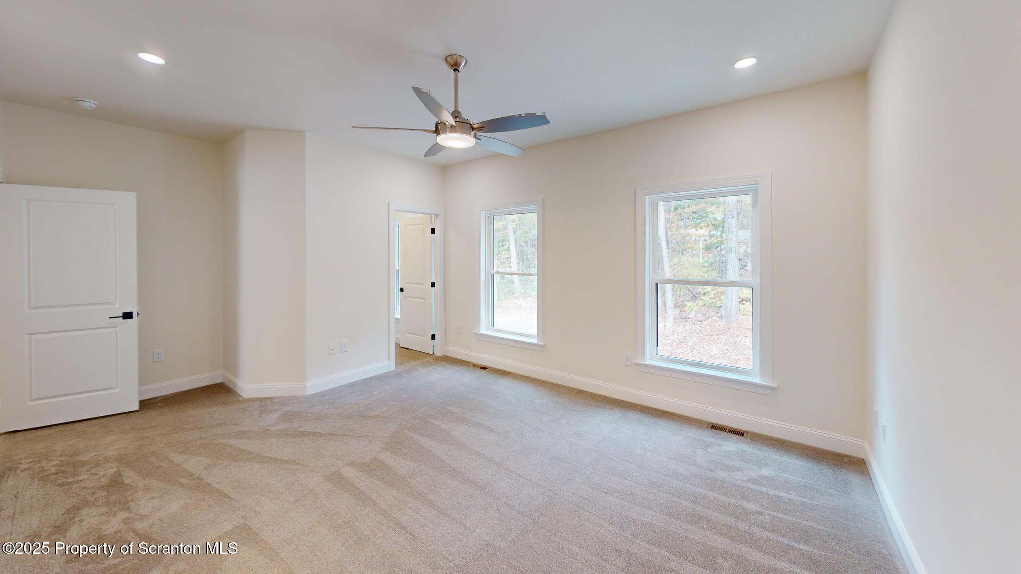 99 Woodland Drive Lake Ariel, PA 18436 - Photo 50 of 124 an empty room with chandelier fan and windows