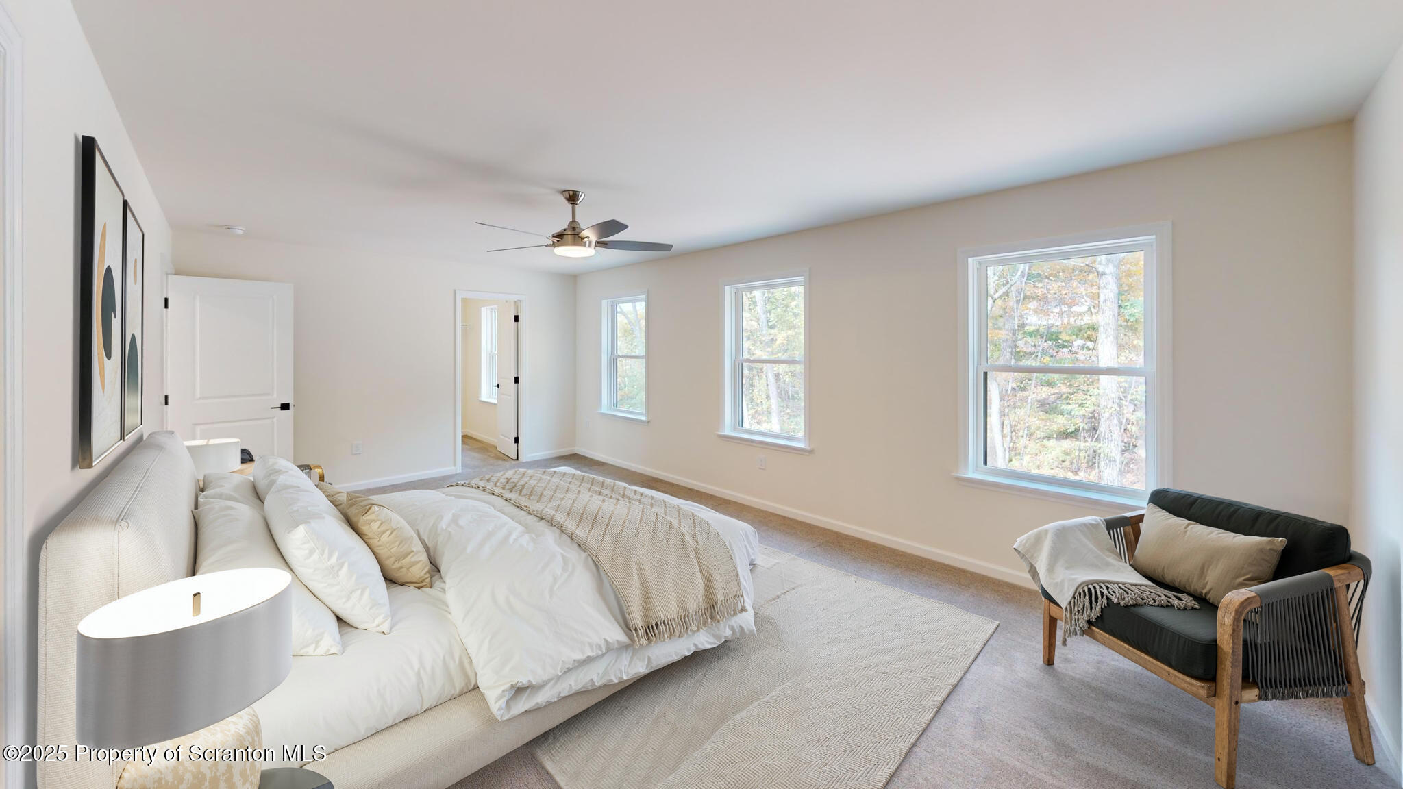 99 Woodland Drive Lake Ariel, PA 18436 - Photo 72 of 124 a spacious bedroom with a bed and a chair