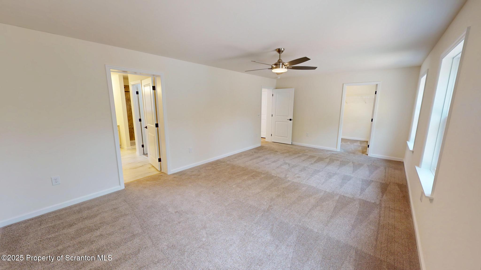 99 Woodland Drive Lake Ariel, PA 18436 - Photo 76 of 124 an empty room with a ceiling fan and a bathroom