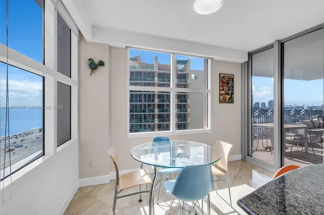 a dining room with furniture and a large window