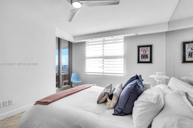 a bedroom with furniture and a large window