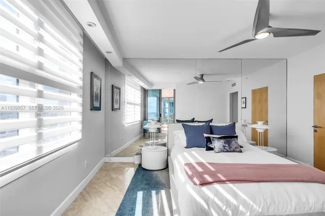 a bathroom with a sink a toilet and shower a mirror