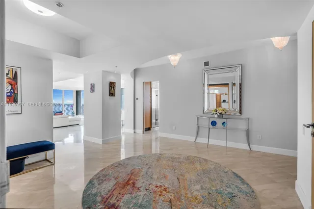 a balcony with wooden floor table and chairs