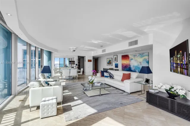 a living room with furniture and large windows