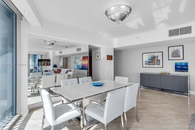 a view of a dining room with furniture and a large window