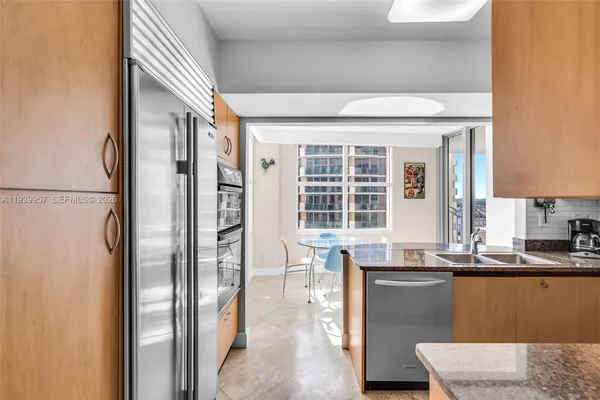 a kitchen with a sink a stove and cabinets