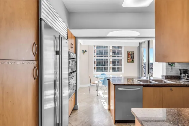 a kitchen with a sink a stove and cabinets