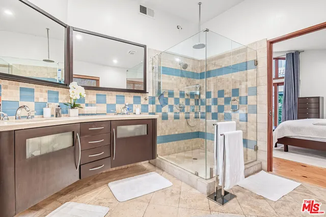 a bedroom with a large bed and a large window