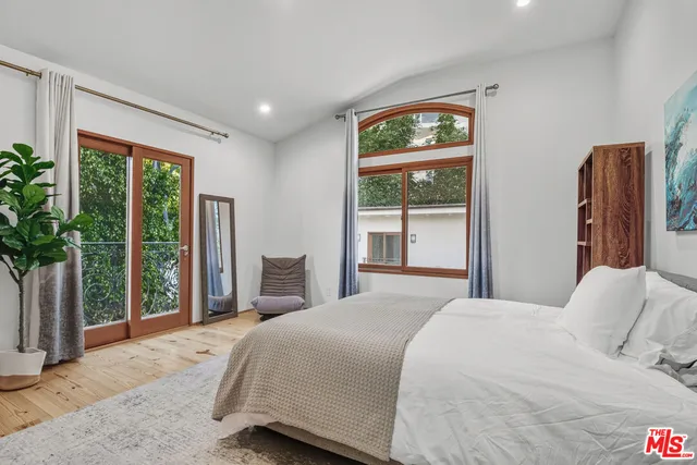 a bathroom with a granite countertop sink a mirror a bathtub and shower
