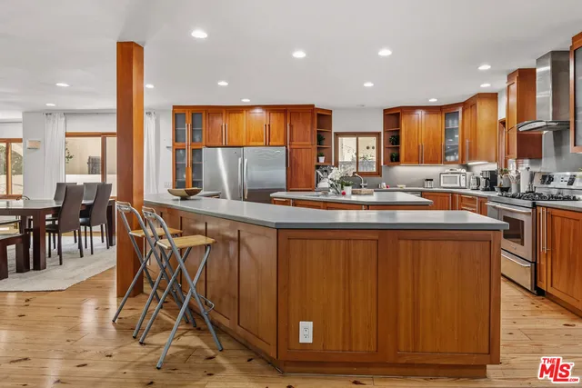 a kitchen with stainless steel appliances granite countertop a sink and stove
