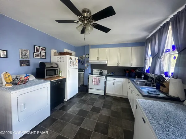 a kitchen with a refrigerator a stove a microwave and cabinets