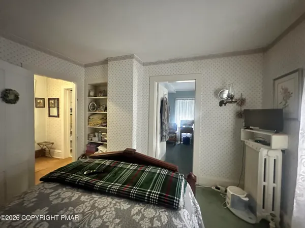 a bedroom with a bed and flat screen tv