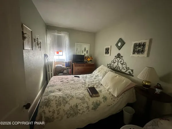 a bed sitting in a bedroom and chair