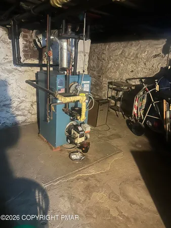 a room with water heater and wooden cabinet