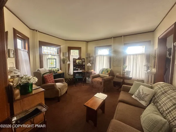 a living room with furniture and a large window