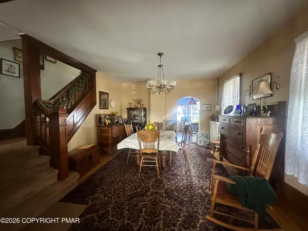 a living room with furniture a rug and a chandelier