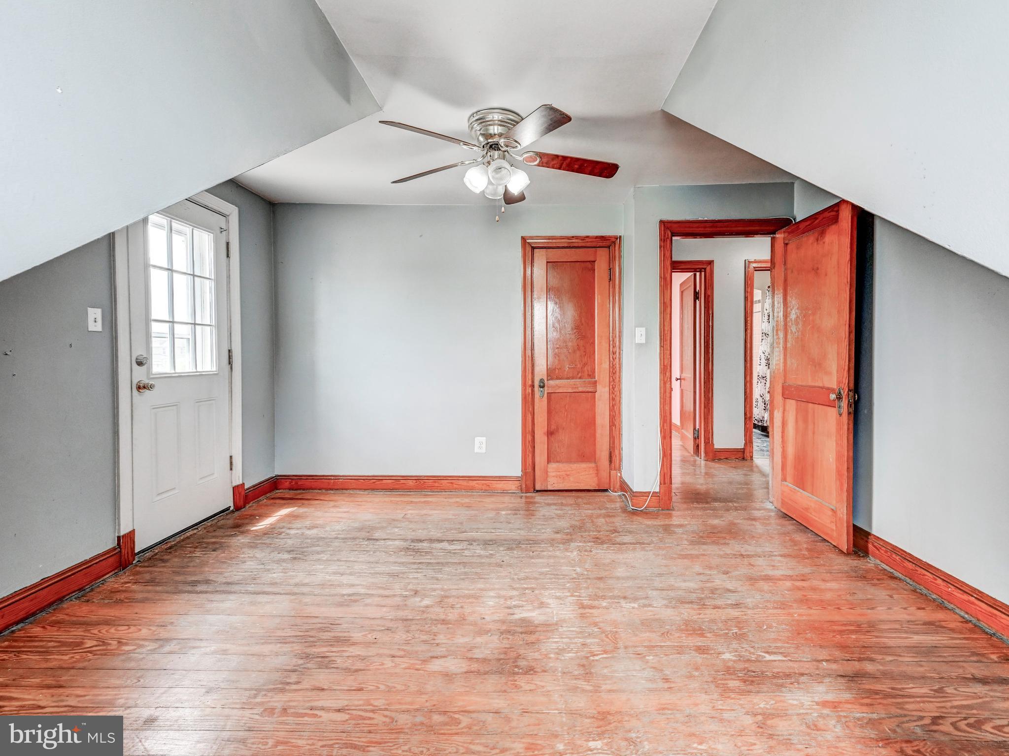 3206 Lynch Road Baltimore, MD 21219 - Photo 29 of 70 a view of an empty room with window and wooden floor
