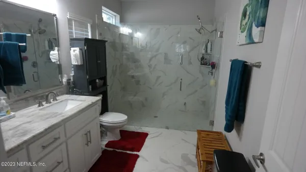 a bathroom with a sink a toilet and a shower