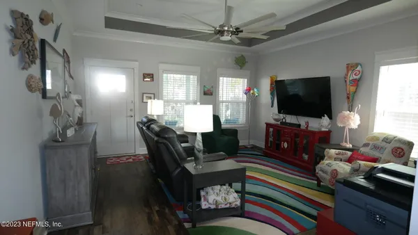 a kitchen with stainless steel appliances granite countertop a stove top oven a refrigerator a stove top oven and a dining table with wooden floor