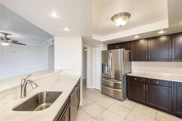 a kitchen with a sink and stainless steel appliances
