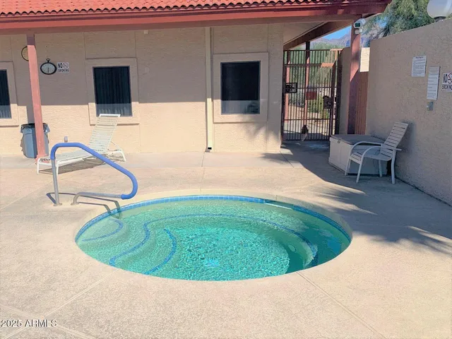 a view of a swimming pool with chairs