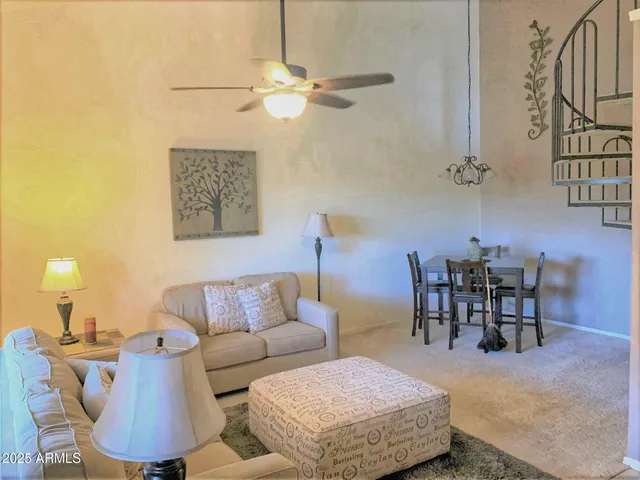 a living room with furniture and a chandelier