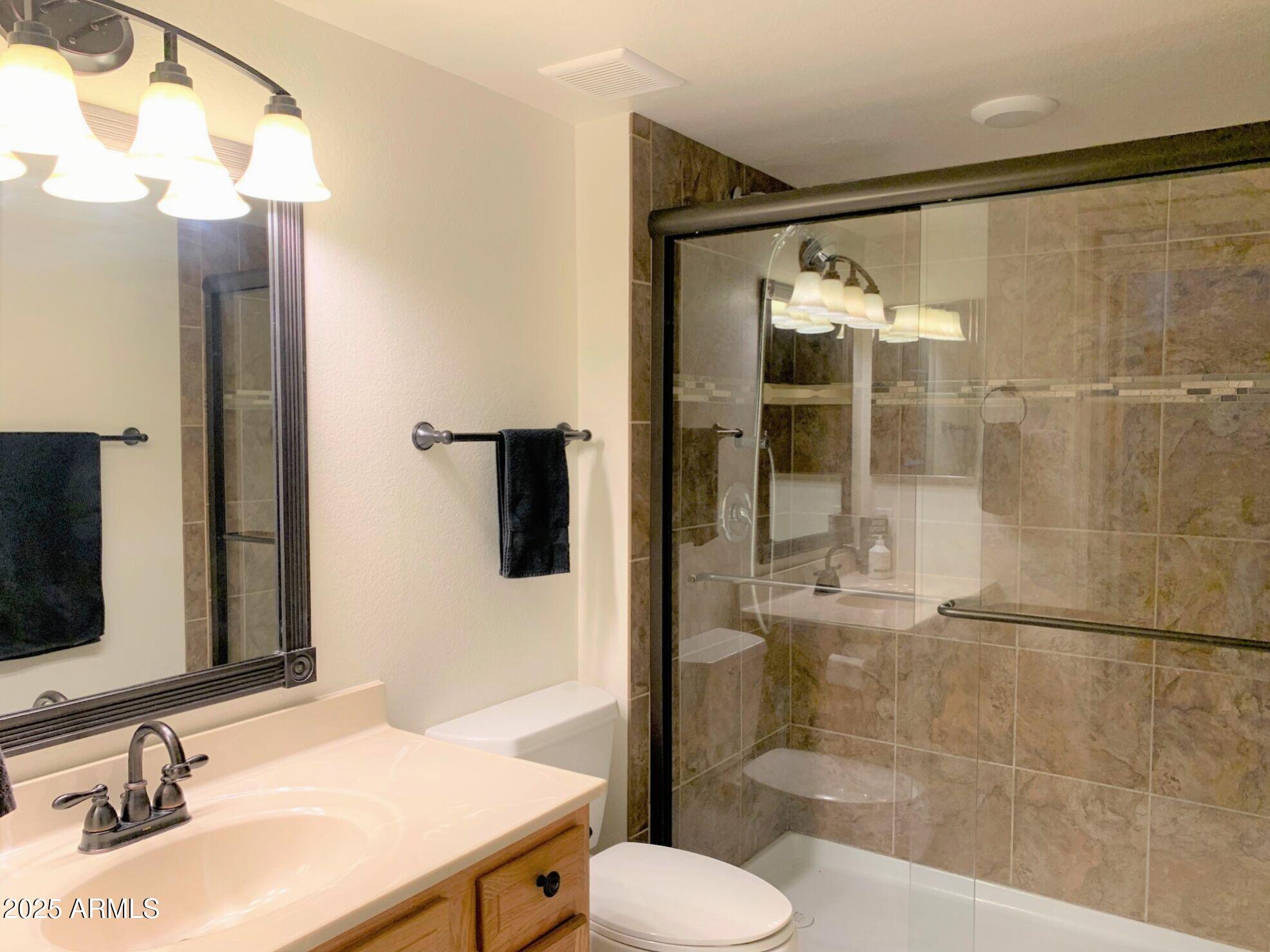 1440 North Idaho Road, Unit 1019 Apache Junction, AZ 85119 - Photo 8 of 14 a bathroom with a sink and a mirror