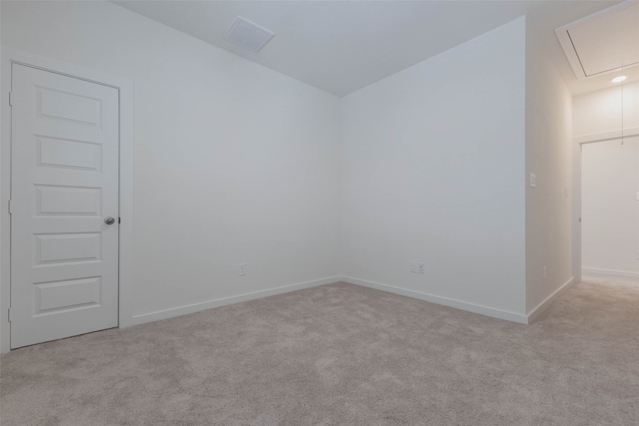 1115 Santee Court Rosharon, TX 77583 - Photo 16 of 23 Another carpeted bedroom is bright and roomy, with space for a queen bed, nightstands and a dresser. A closet door sits to the left, and an attic access in the ceiling gives bonus storage for seasonal items. Fresh white paint and plush carpet make this a comfortable, move-in-ready room for family, guests or a quiet home office.