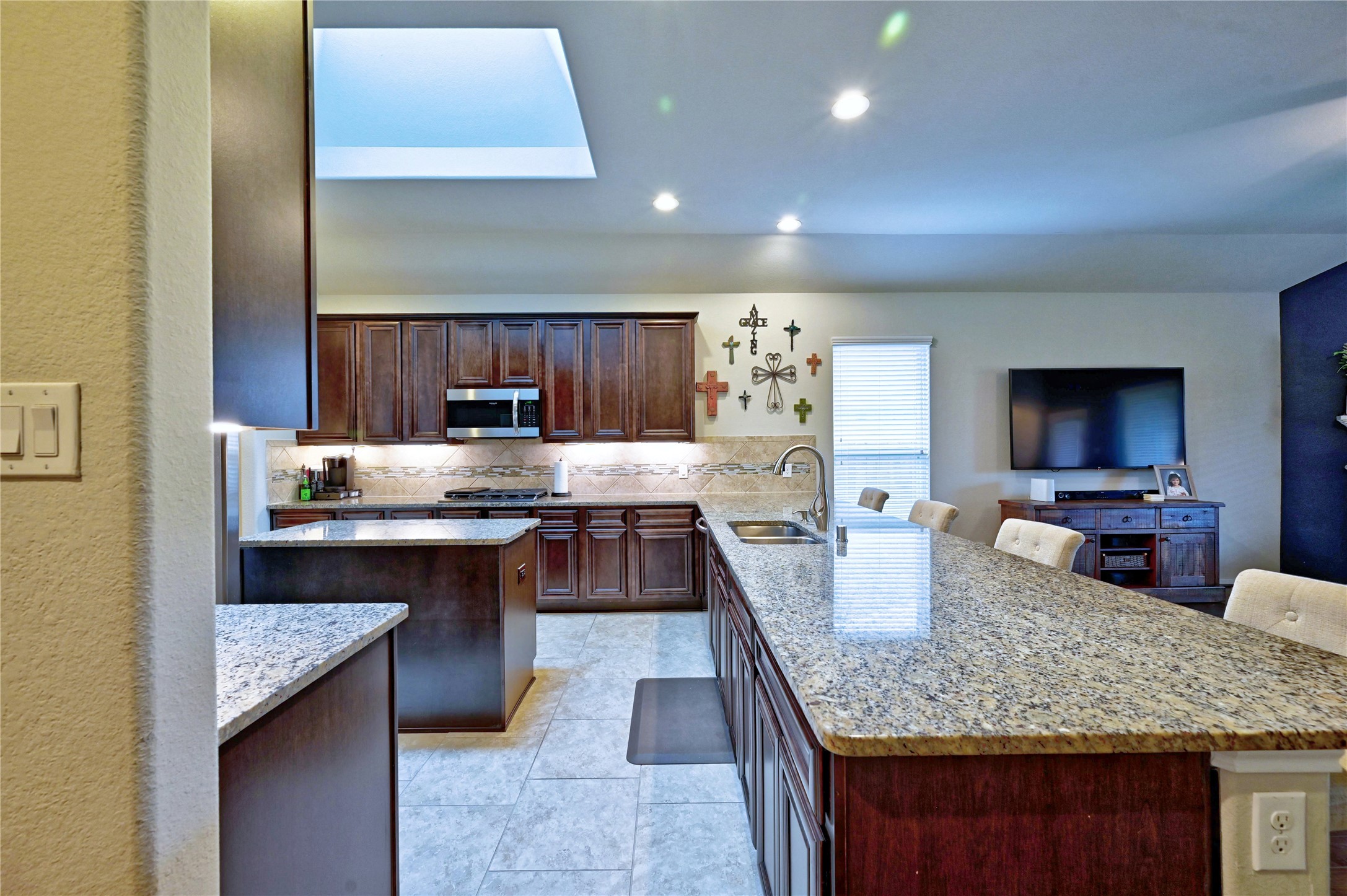 23118 Southern Brk Trail Spring, TX 77389 - Photo 16 of 50 This house boasts a huge gourmet kitchen complete with updated five-burner Samsung stove. There is a separate island and a sky light to add to the ambiance. The kitchen has tile flooring and granite countertops as well.