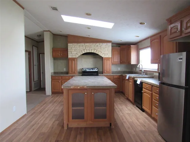 a kitchen with a stove a sink and a refrigerator