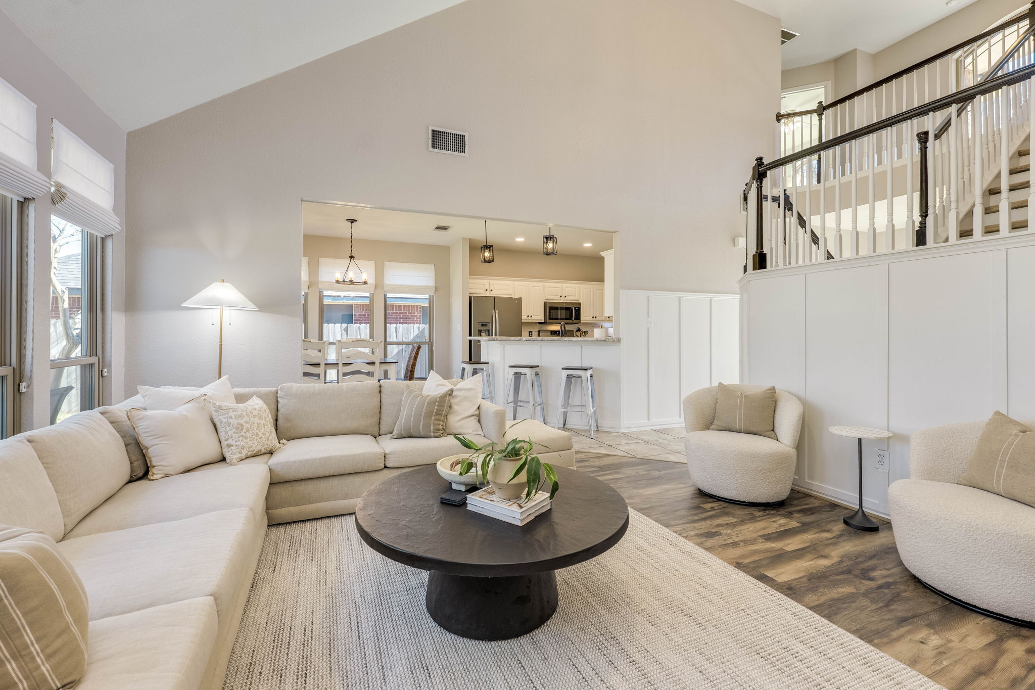 703 Ridge View Drive Leander, TX 78641 - Photo 11 of 39 Living room featuring wood finished floors, a decorative wall, lofted ceiling, and a wainscoted wall
