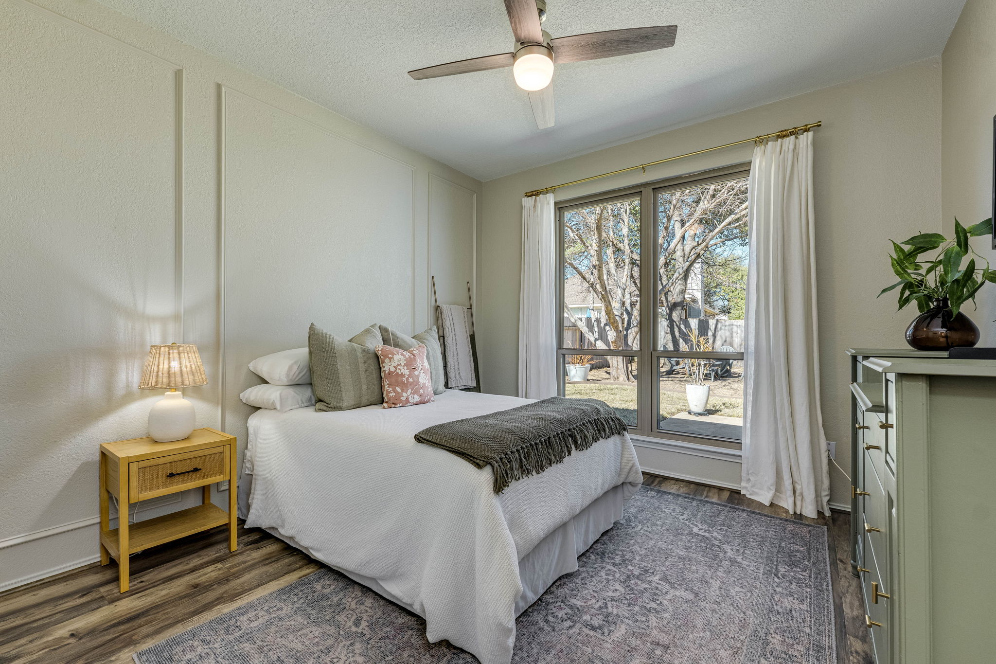 703 Ridge View Drive Leander, TX 78641 - Photo 19 of 39 Bedroom featuring dark wood-type flooring, a ceiling fan, a decorative wall, and a textured ceiling