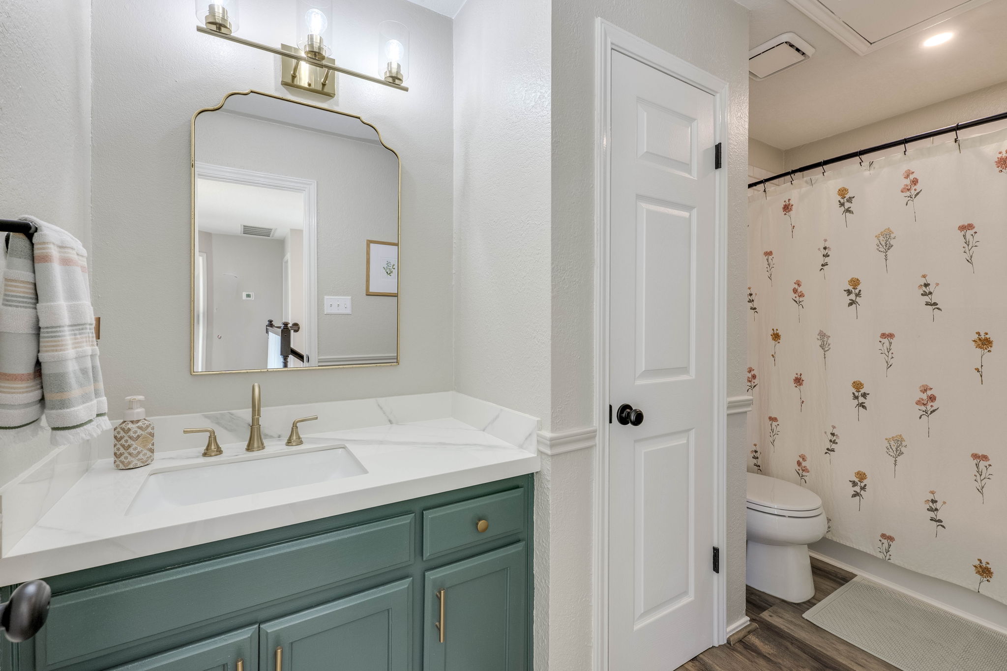 703 Ridge View Drive Leander, TX 78641 - Photo 25 of 39 Bathroom featuring vanity, a shower with curtain, and dark wood-style flooring