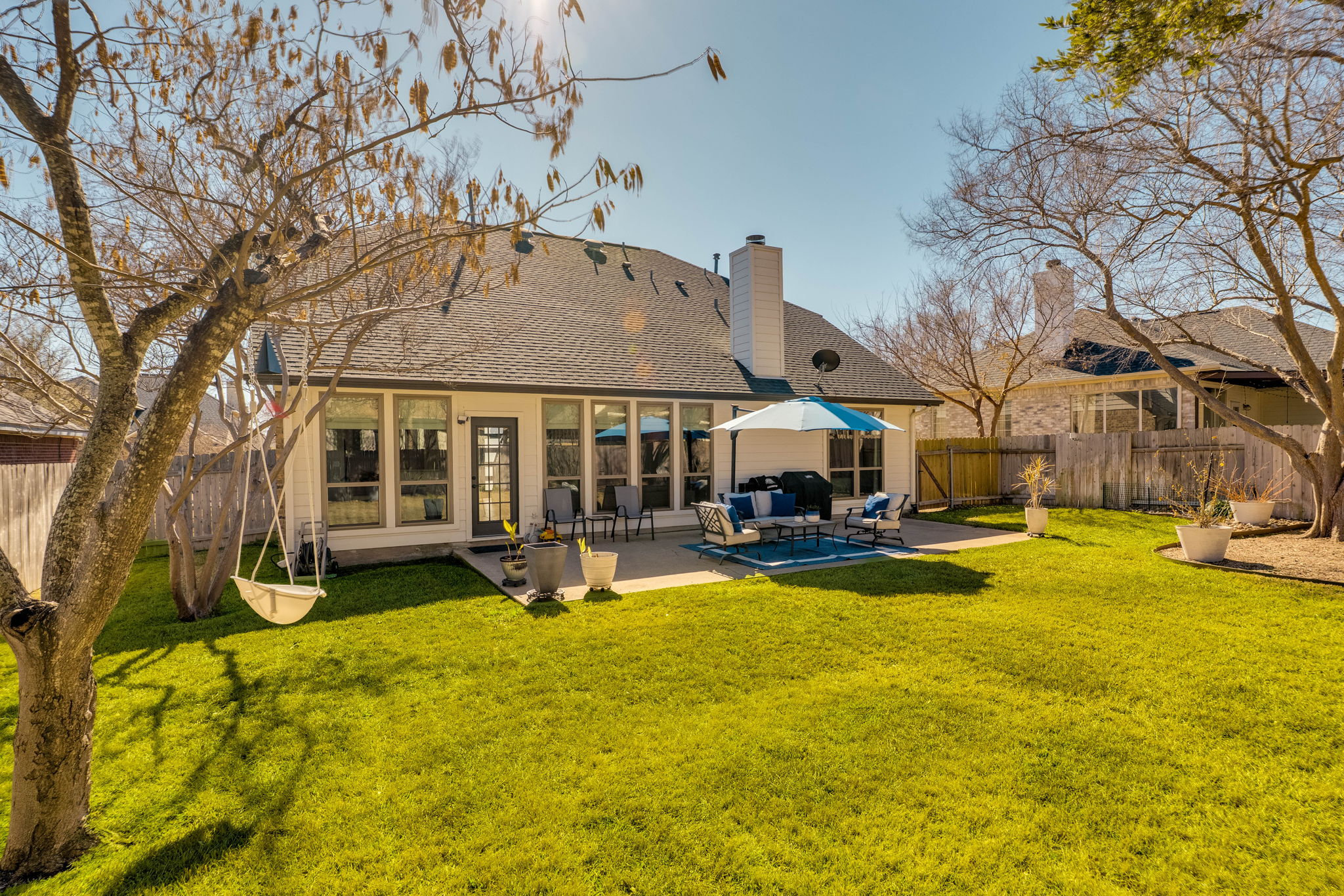 703 Ridge View Drive Leander, TX 78641 - Photo 39 of 39 Rear view of house featuring an outdoor hangout area, a fenced backyard, a patio area, roof with shingles, and a chimney