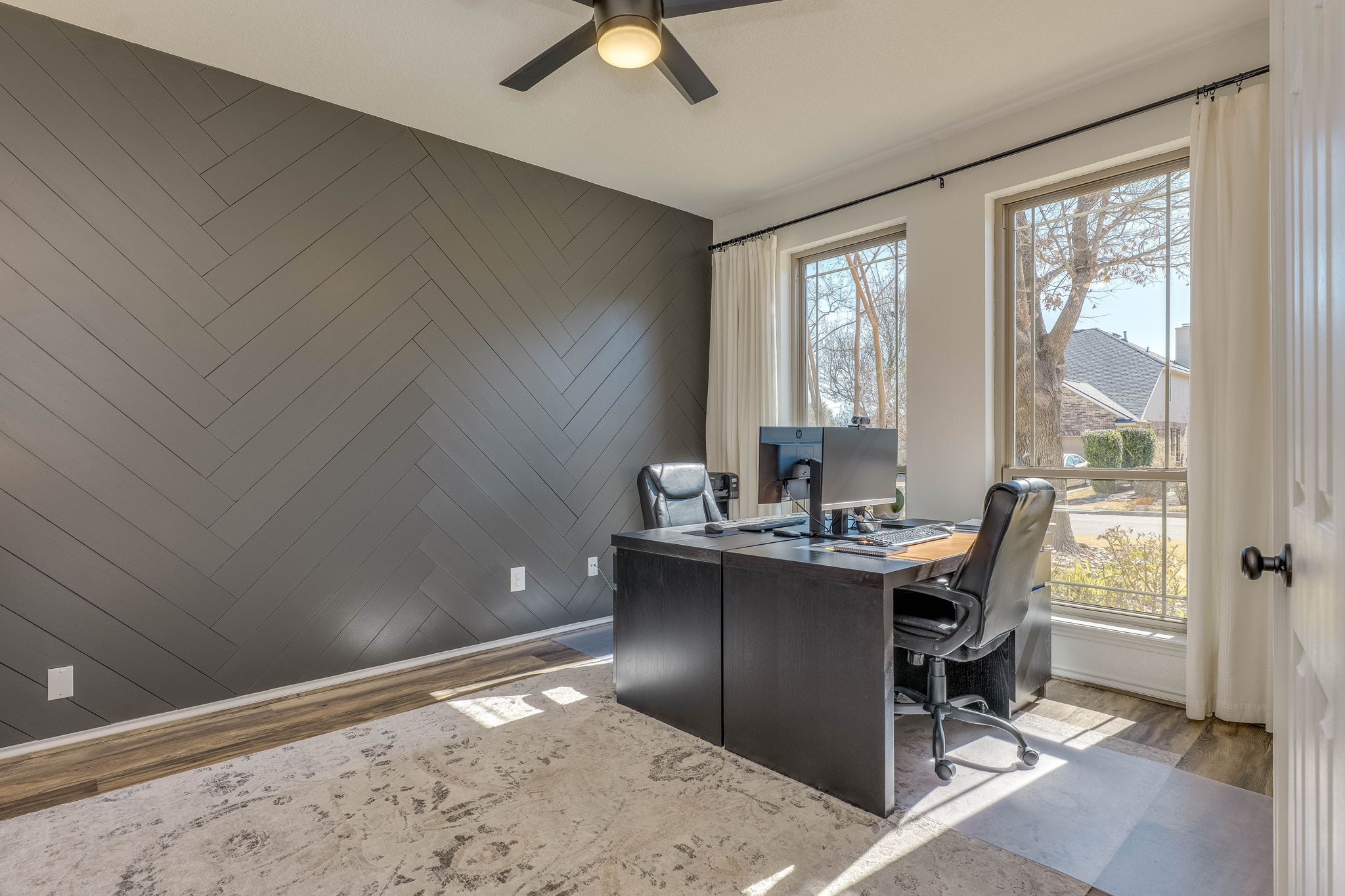703 Ridge View Drive Leander, TX 78641 - Photo 6 of 39 Office featuring wood walls, wood finished floors, ceiling fan, and an accent wall