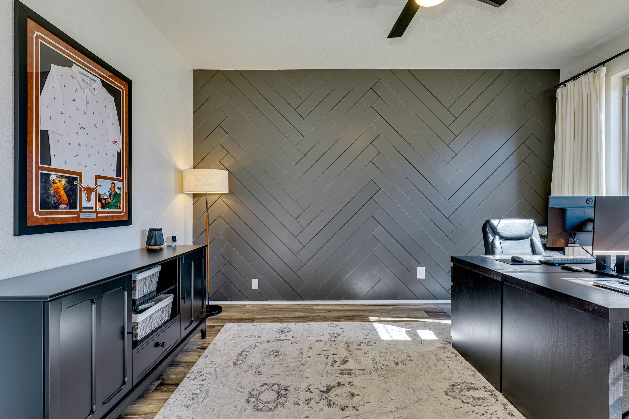 703 Ridge View Drive Leander, TX 78641 - Photo 7 of 39 Office area featuring wood finished floors, a ceiling fan, an accent wall, and wood walls