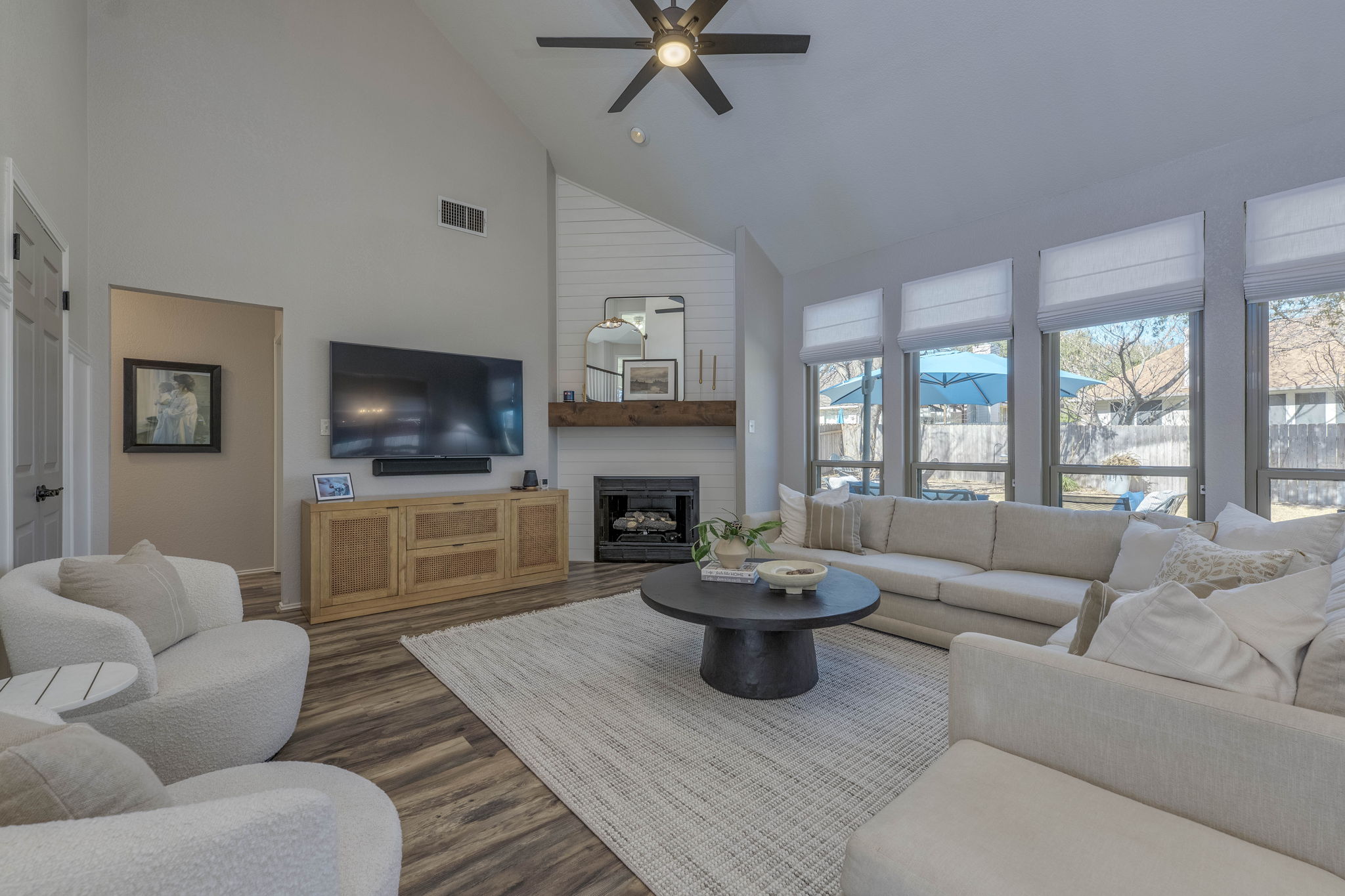 703 Ridge View Drive Leander, TX 78641 - Photo 8 of 39 Living room with wood finished floors, a large fireplace, ceiling fan, lofted ceiling, and recessed lighting