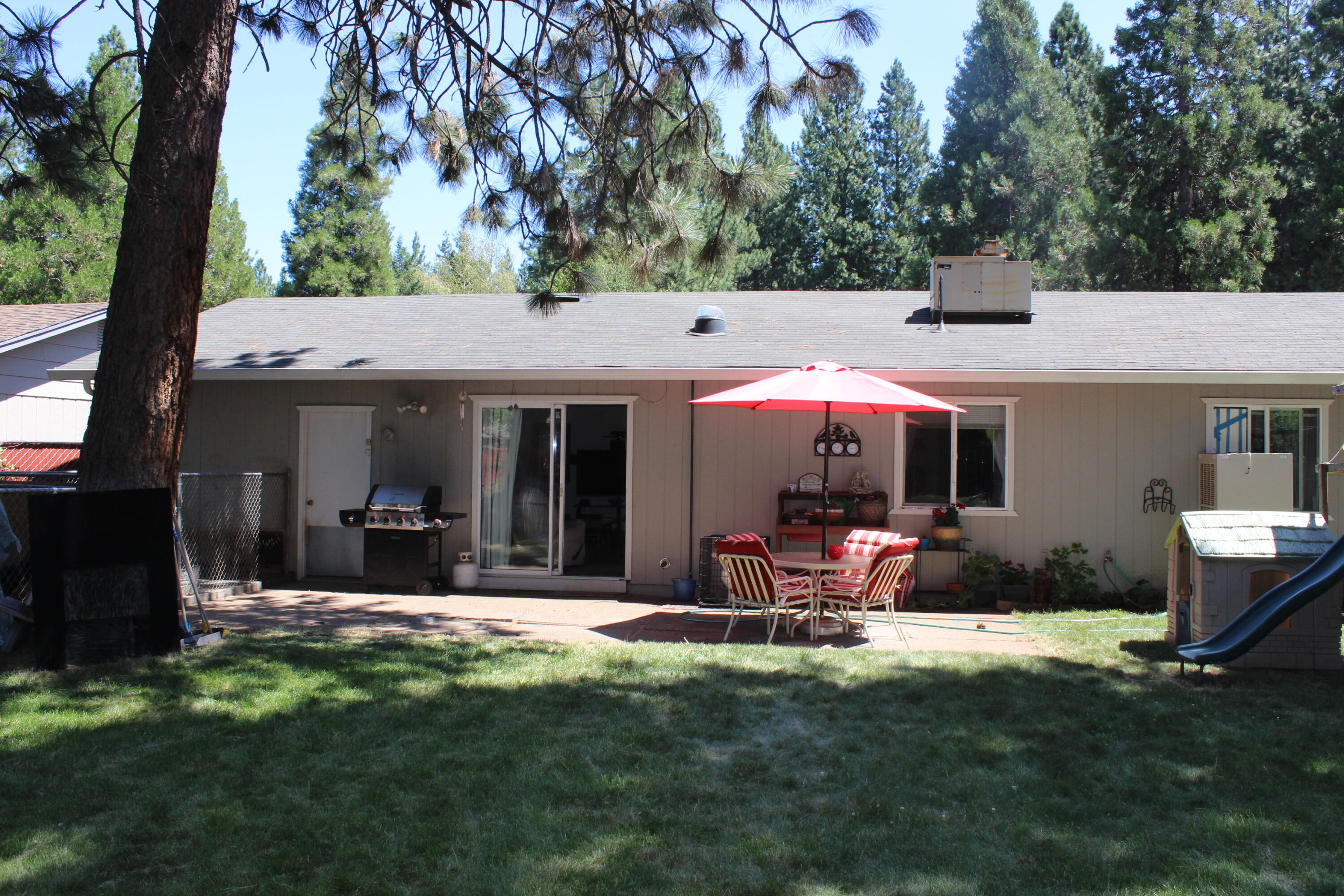 20244 Arrowood Street Burney, CA 96013 - Photo 11 of 19 a view of a house with backyard porch and sitting area