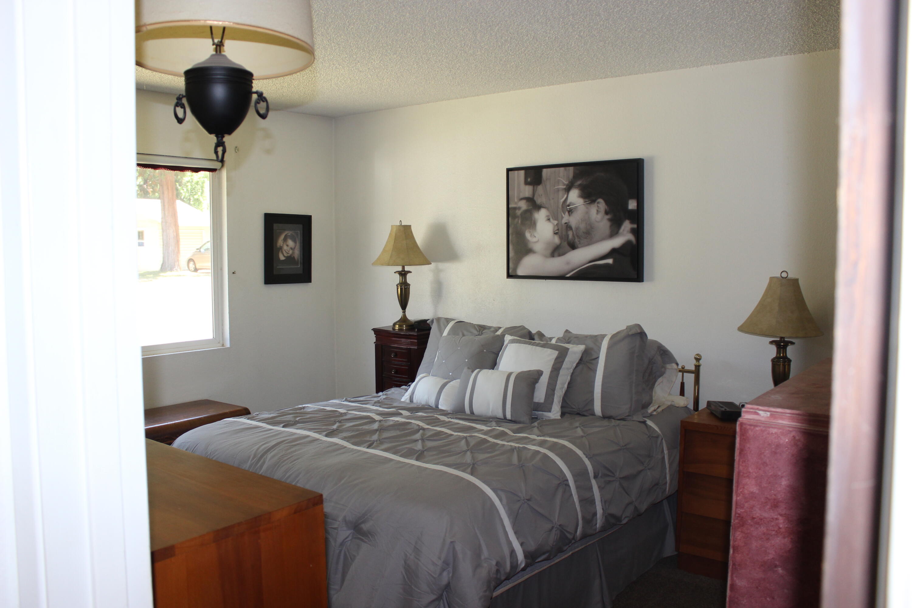 20244 Arrowood Street Burney, CA 96013 - Photo 17 of 19 a bedroom with a bed and a painting on the wall