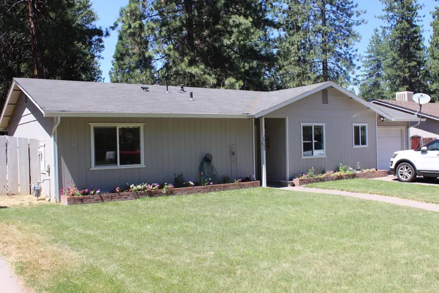 a front view of a house with a yard