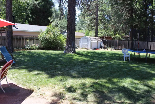 a view of a house with backyard porch and sitting area